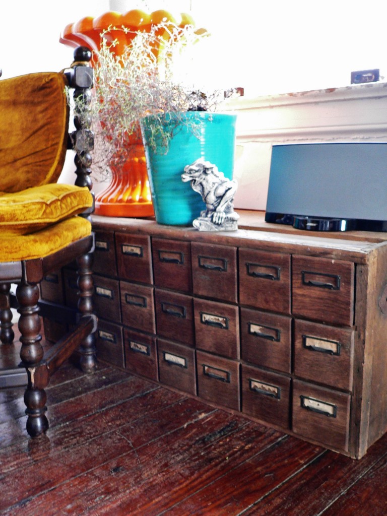 A card catalog-looking feed container. The drawers actually pull out, and the interiors are metal sheeting. This holds my select design magazines (a few rolled up into each) from years past.