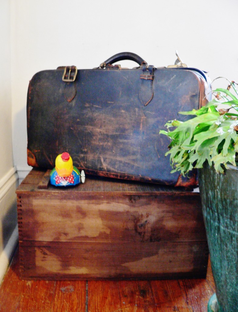 This biscuit box holds photo frames and other little things, and the cool piece of luggage holds old newspaper clippings.